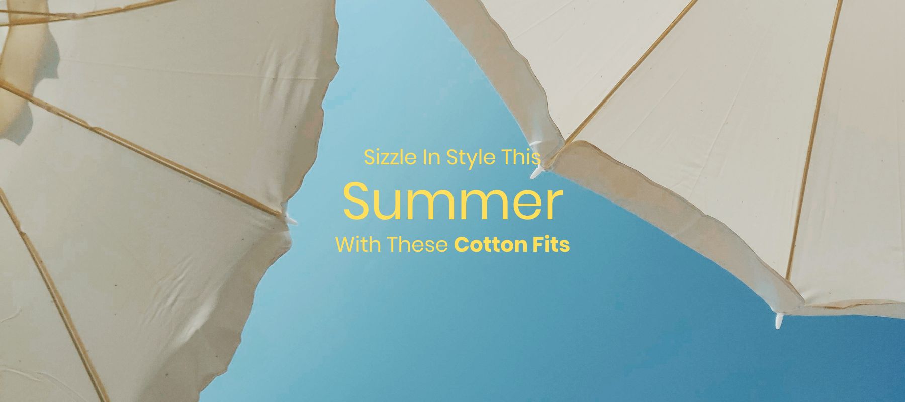 White umbrellas against blue summer sky.